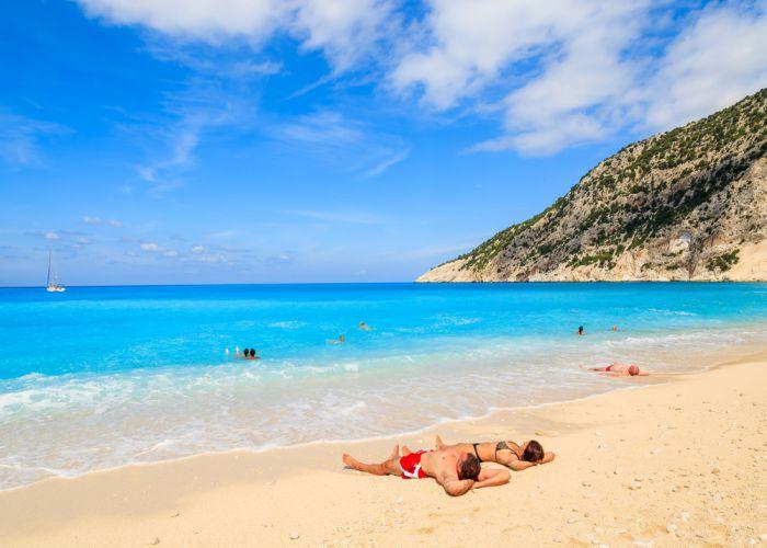 couple layinh in myrtos beach kefalonia Pawel Kazmierczak shutterstock