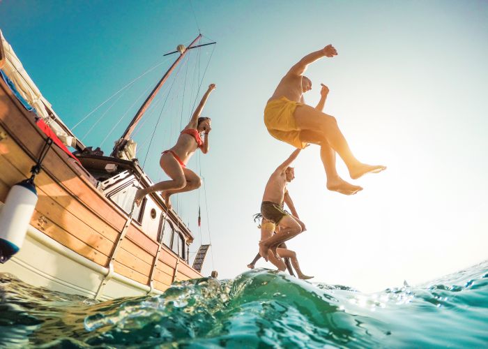 jumping int the sea from sailboat DisobeyArt shutterstock