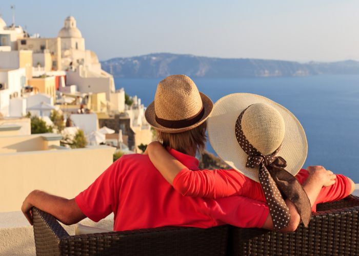 couple enjoying Santorini NadyaEugene shutterstock