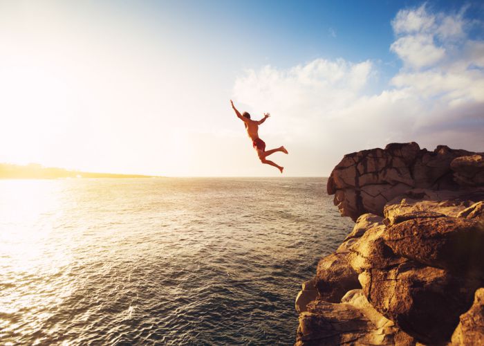 cliff jumping into ocean