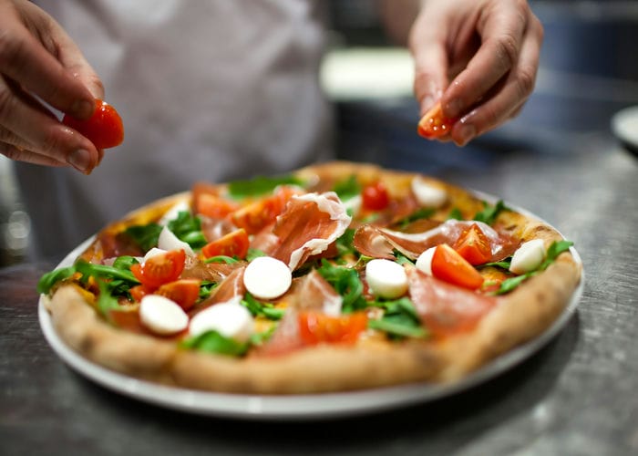 chef making pizza